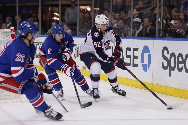 Feb 28, 2024; New York, New York, USA; Columbus Blue Jackets left wing Alexander Nylander (92) controls the puck against New York Rangers defenseman Jacob Trouba (8) and left wing Chris Kreider (20) during the third period at Madison Square Garden. Mandatory Credit: Brad Penner-USA TODAY Sports