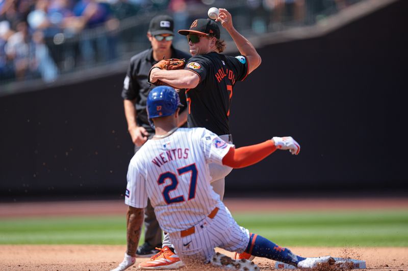 Aug 21, 2024; New York City, New York, USA; Baltimore Orioles second baseman Jackson Holliday (7) attempts to turn a double play after forcing out New York Mets third baseman Mark Vientos (27) at second base during the fifth inning at Citi Field. Mandatory Credit: Vincent Carchietta-USA TODAY Sports
