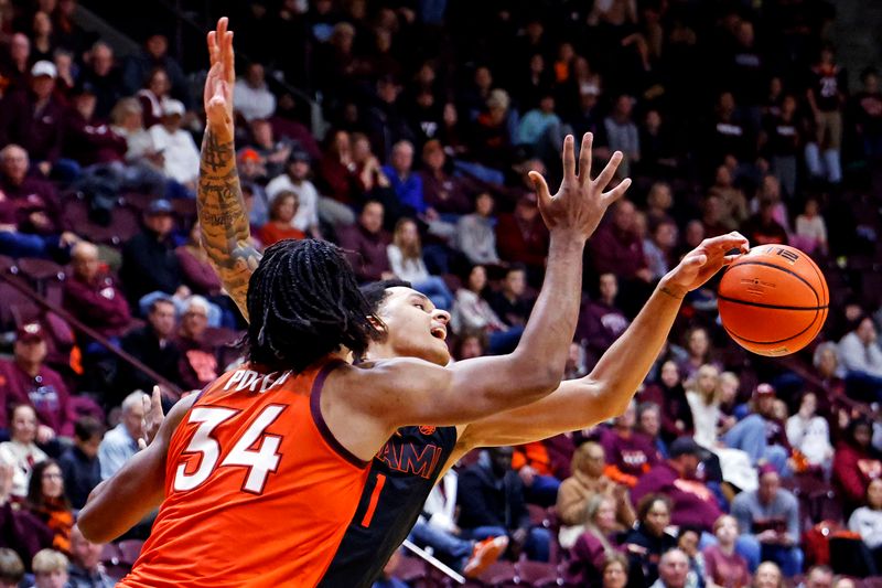 Jan 4, 2025; Blacksburg, Virginia, USA; Miami Hurricanes center Lynn Kidd (1) and Virginia Tech Hokies forward Mylyjael Poteat (34) go for the ball during the second half at Cassell Coliseum. Mandatory Credit: Peter Casey-Imagn Images