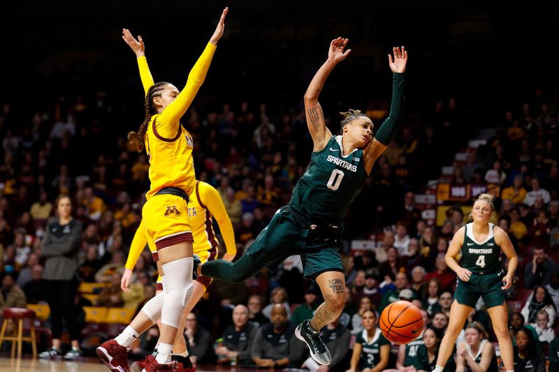 Jan 20, 2024; Minneapolis, Minnesota, USA; Michigan State Spartans guard DeeDee Hagemann (0) loses control of the ball as Minnesota Golden Gophers guard Amaya Battle (3) defends during the second half at Williams Arena. Mandatory Credit: Matt Krohn-USA TODAY Sports