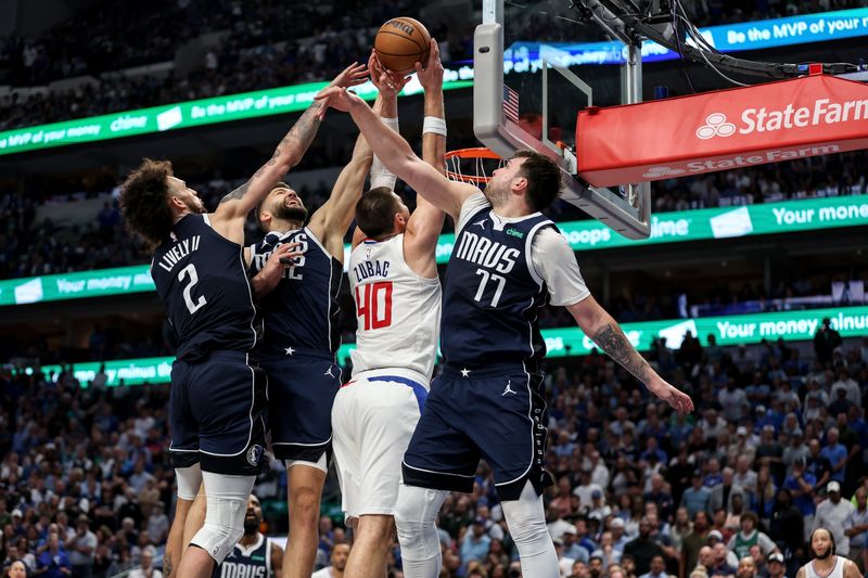 DALLAS, TEXAS - APRIL 28: Ivica Zubac #40 of the Los Angeles Clippers has a shot defended by Maxi Kleber #42, Dereck Lively II #2 and Luka Doncic #77 of the Dallas Mavericks in the second half of game four of the Western Conference First Round Playoffs at American Airlines Center on April 28, 2024 in Dallas, Texas.  NOTE TO USER: User expressly acknowledges and agrees that, by downloading and or using this photograph, User is consenting to the terms and conditions of the Getty Images License Agreement. (Photo by Tim Warner/Getty Images)