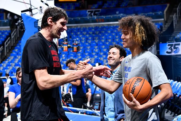 ORLANDO, FL - OCTOBER 25: Anthony Black #0 of the Orlando Magic shakes hands with Boban Marjanovic #51 of the Houston Rockets before the game on October 25, 2023 at Amway Center in Orlando, Florida. NOTE TO USER: User expressly acknowledges and agrees that, by downloading and or using this photograph, User is consenting to the terms and conditions of the Getty Images License Agreement. Mandatory Copyright Notice: Copyright 2023 NBAE (Photo by Gary Bassing/NBAE via Getty Images)