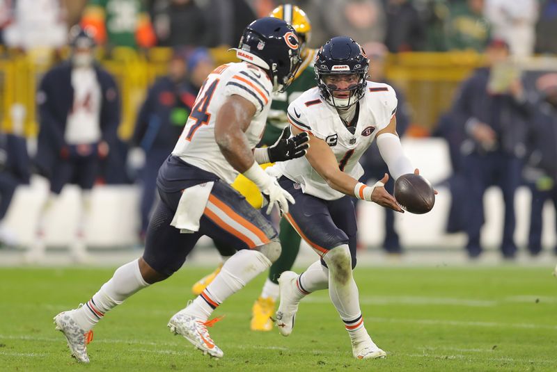 Chicago Bears quarterback Justin Fields (1) hands off the football during an NFL football game against the Green Bay Packers, Sunday, Jan. 07, 2024, in Green Bay. (AP Photo/Melissa Tamez)