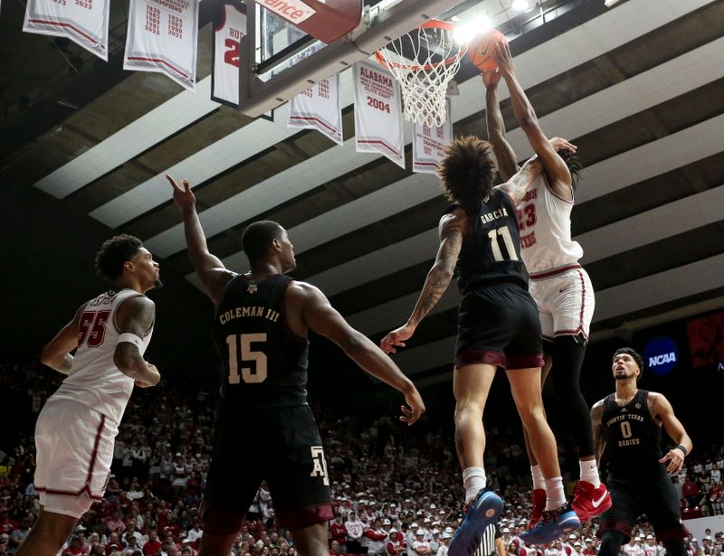 Feb 17, 2024; Tuscaloosa, Alabama, USA;  Texas A&M Aggies forward Andersson Garcia (11) fouls Alabama Crimson Tide forward Nick Pringle (23) to prevent a dunk during the second half at Coleman Coliseum. Alabama won 100-75. Mandatory Credit: Gary Cosby Jr.-USA TODAY Sports