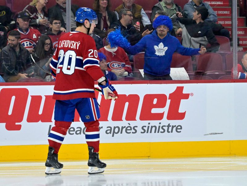 Oct 9, 2024; Montreal, Quebec, CAN; A Toronto Maple Leafs fan taunts Montreal Canadiens forward Juraj Slafkovsky (20) during the third period at the Bell Centre. Mandatory Credit: Eric Bolte-Imagn Images