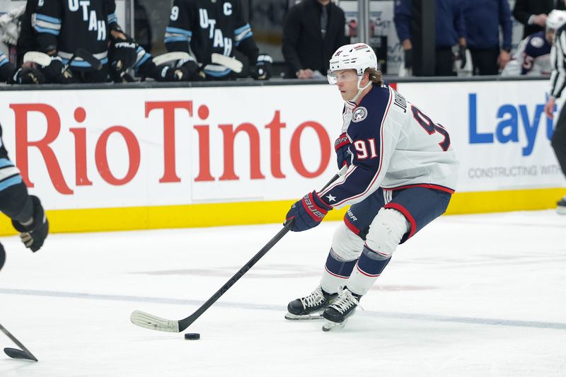 Jan 31, 2025; Salt Lake City, Utah, USA;  Columbus Blue Jackets center Kent Johnson (91) controls the puck during the first period against the Utah Hockey Club at Delta Center. Mandatory Credit: Chris Nicoll-Imagn Images