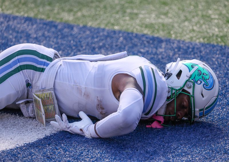 Oct 28, 2023; Houston, Texas, USA; Tulane Green Wave wide receiver Jha'Quan Jackson (4) lays on the turf after hitting the ground with his head while trying to catch a pass against the Rice Owls in the first half at Rice Stadium. Mandatory Credit: Thomas Shea-USA TODAY Sports