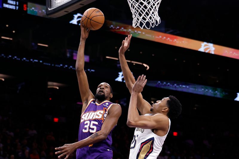 PHOENIX, ARIZONA - APRIL 07: Kevin Durant #35 of the Phoenix Suns lays up shot against Trey Murphy III #25 of the New Orleans Pelicans during the first half at Footprint Center on April 07, 2024 in Phoenix, Arizona. NOTE TO USER: User expressly acknowledges and agrees that, by downloading and or using this photograph, User is consenting to the terms and conditions of the Getty Images License Agreement.  (Photo by Chris Coduto/Getty Images)