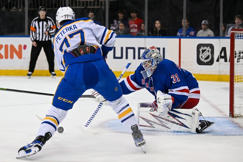 Nov 7, 2024; New York, New York, USA;  New York Rangers goaltender Igor Shesterkin (31) makes a save on Buffalo Sabres right wing JJ Peterka (77) during the first period at Madison Square Garden. Mandatory Credit: Dennis Schneidler-Imagn Images