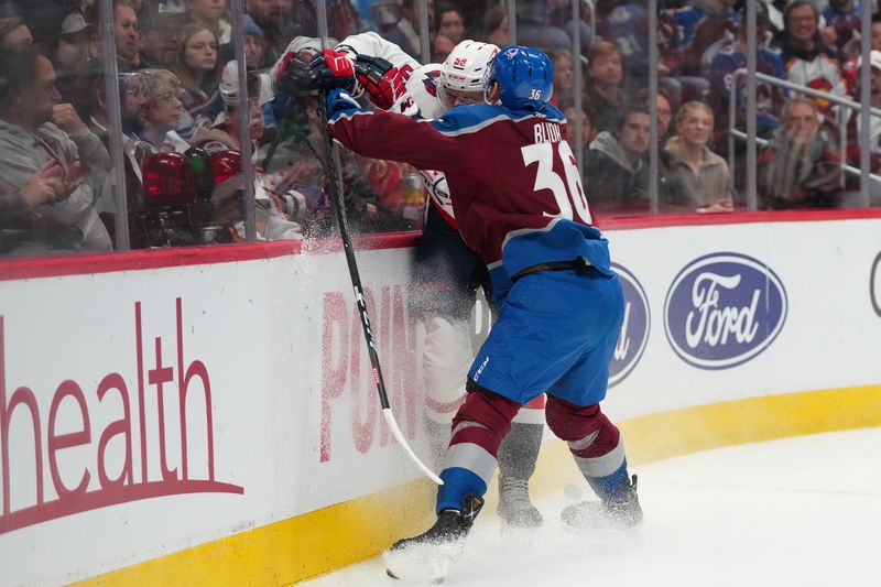 Jan 24, 2023; Denver, Colorado, USA; Colorado Avalanche left wing Anton Blidh (36) checks Washington Capitals center Aliaksei Protas (59) in the second period at Ball Arena. Mandatory Credit: Ron Chenoy-USA TODAY Sports