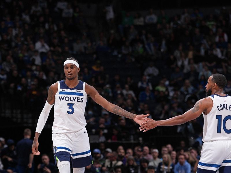 MINNEAPOLIS, MN -  MARCH 27: Jaden McDaniels #3 and Mike Conley #10 of the Minnesota Timberwolves high five during the game against the Detroit Pistons on March 27, 2024 at Target Center in Minneapolis, Minnesota. NOTE TO USER: User expressly acknowledges and agrees that, by downloading and or using this Photograph, user is consenting to the terms and conditions of the Getty Images License Agreement. Mandatory Copyright Notice: Copyright 2024 NBAE (Photo by Jordan Johnson/NBAE via Getty Images)