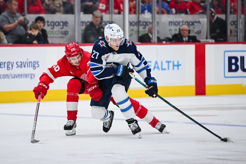 Oct 30, 2024; Detroit, Michigan, USA; Winnipeg Jets left wing Nikolaj Ehlers (27) brings the puck up ice as Detroit Red Wings defenseman Albert Johansson (20) defends during the third period at Little Caesars Arena. Mandatory Credit: Tim Fuller-Imagn Images