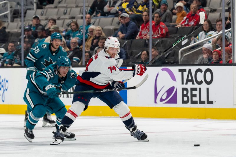 Nov 27, 2023; San Jose, California, USA; Washington Capitals defenseman John Carlson (74) and San Jose Sharks center William Eklund (72) battle for the puck during the second period at SAP Center at San Jose. Mandatory Credit: Neville E. Guard-USA TODAY Sports