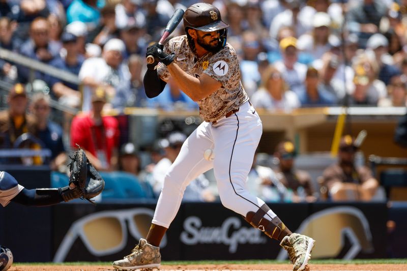 May 26, 2024; San Diego, California, USA; San Diego Padres right fielder Fernando Tatis Jr. (23) is hit by a pitch while batting in the first inning against the New York Yankees at Petco Park. Mandatory Credit: David Frerker-USA TODAY Sports