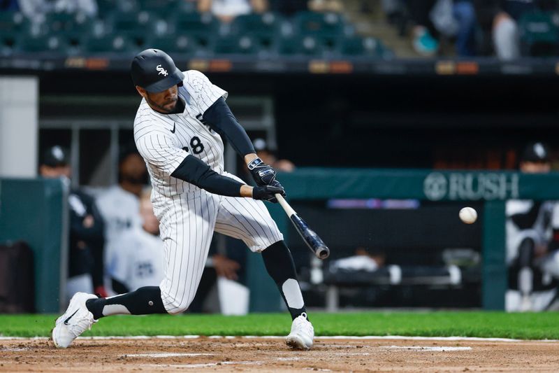 May 9, 2024; Chicago, Illinois, USA; Chicago White Sox outfielder Tommy Pham (28) hits an RBI-single against the Cleveland Guardians during the second inning at Guaranteed Rate Field. Mandatory Credit: Kamil Krzaczynski-USA TODAY Sports