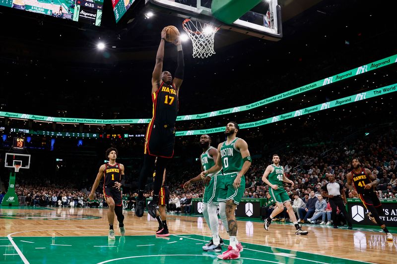 BOSTON, MA - FEBRUARY 7: Onyeka Okongwu #17 of the Atlanta Hawks dunks as Jayson Tatum #0 of the Boston Celtics looks on during the second quarter at TD Garden on February 7, 2024 in Boston, Massachusetts. NOTE TO USER: User expressly acknowledges and agrees that, by downloading and/or using this Photograph, user is consenting to the terms and conditions of the Getty Images License Agreement. (Photo By Winslow Townson/Getty Images)