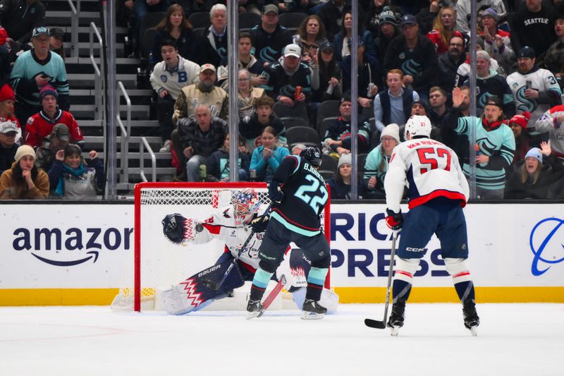 Jan 23, 2025; Seattle, Washington, USA; Washington Capitals goaltender Charlie Lindgren (79) blocks a goal shot by Seattle Kraken right wing Oliver Bjorkstrand (22) during the second period at Climate Pledge Arena. Mandatory Credit: Steven Bisig-Imagn Images