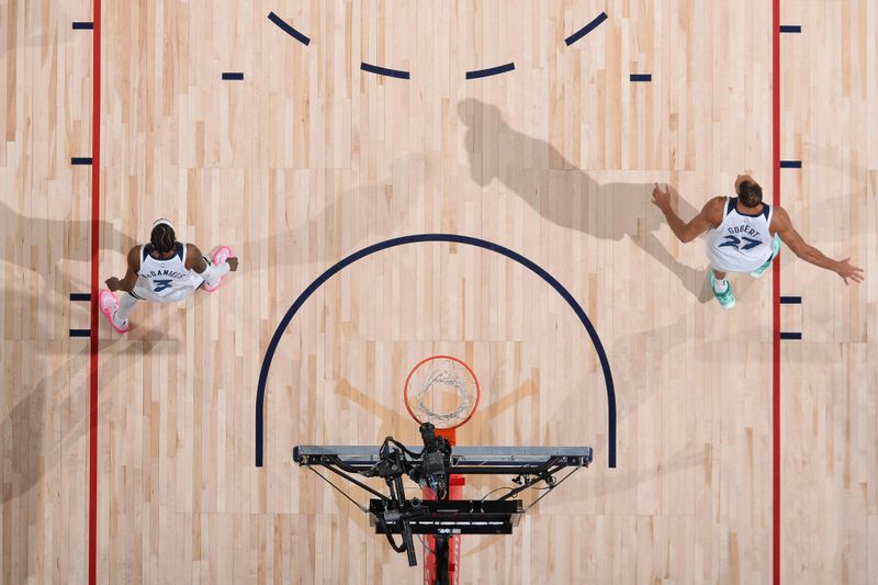 DENVER, CO - APRIL 10: Jaden McDaniels #3 and Rudy Gobert #27 of the Minnesota Timberwolves look on during the game against the Denver Nuggets on April 10, 2024 at the Ball Arena in Denver, Colorado. NOTE TO USER: User expressly acknowledges and agrees that, by downloading and/or using this Photograph, user is consenting to the terms and conditions of the Getty Images License Agreement. Mandatory Copyright Notice: Copyright 2024 NBAE (Photo by Bart Young/NBAE via Getty Images)