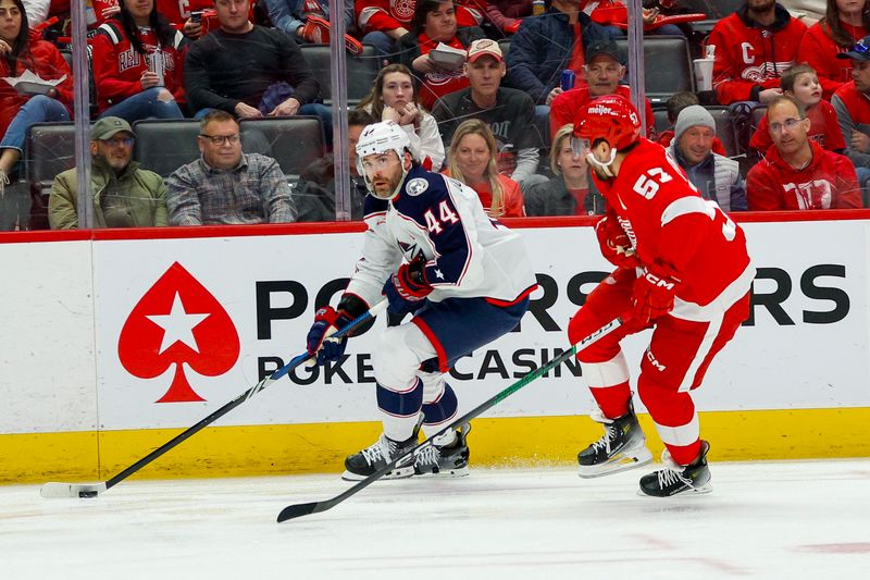 Mar 19, 2024; Detroit, Michigan, USA; Columbus Blue Jackets defenseman Erik Gudbranson (44) handles the puck against Detroit Red Wings left wing David Perron (57) during the first period of the game against the Detroit Red Wings at Little Caesars Arena. Mandatory Credit: Brian Bradshaw Sevald-USA TODAY Sports