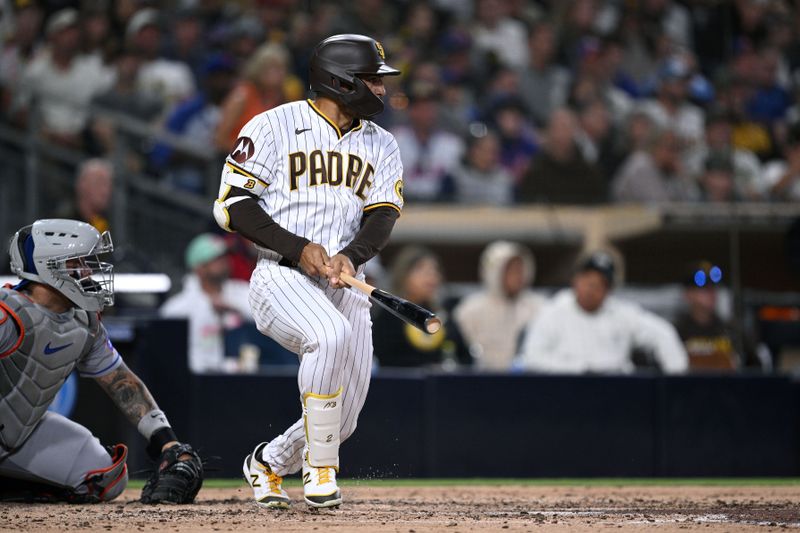 Jul 8, 2023; San Diego, California, USA; San Diego Padres center fielder Trent Grisham (1) hits a single against the New York Mets during the fourth inning at Petco Park. Mandatory Credit: Orlando Ramirez-USA TODAY Sports