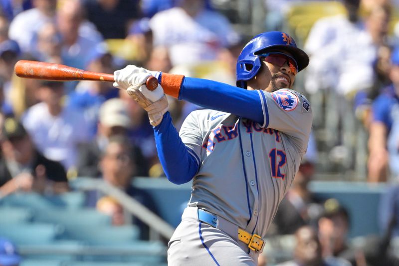 Oct 14, 2024; Los Angeles, California, USA; New York Mets shortstop Francisco Lindor (12) hits a solo home run in the first inning against the Los Angeles Dodgers during game two of the NLCS for the 2024 MLB Playoffs at Dodger Stadium. Mandatory Credit: Jayne Kamin-Oncea-Imagn Images