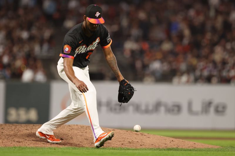 Jun 3, 2025; San Francisco, California, USA;  San Francisco Giants relief pitcher Camilo Doval (75) gathers the ball against the San Diego Padres during the ninth inning at Oracle Park. Mandatory Credit: Kelley L Cox-Imagn Images