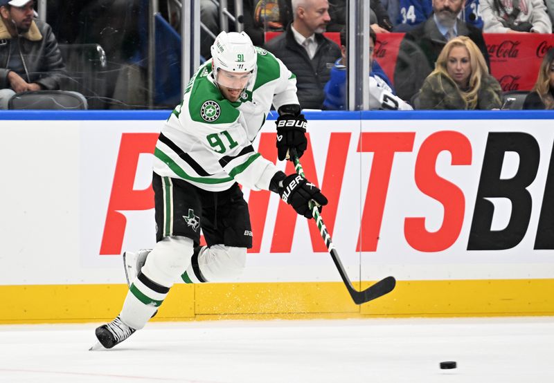 Feb 7, 2024; Toronto, Ontario, CAN; Dallas Stars forward Tyler Seguin (91) passes the puck against the Toronto Maple Leafs in the third period at Scotiabank Arena. Mandatory Credit: Dan Hamilton-USA TODAY Sports