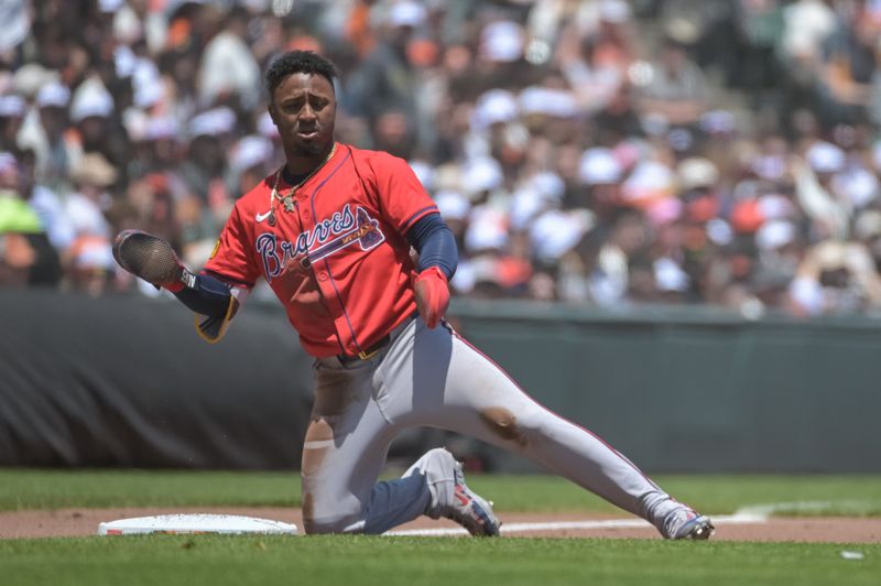 Jun 7, 2025; San Francisco, California, USA;  Atlanta Braves second baseman Ozzie Albies (1) motions to his team mates after advancing to third base during the third inning of the game against the San Francisco Giants at Oracle Park. Mandatory Credit: Ed Szczepanski-Imagn Images