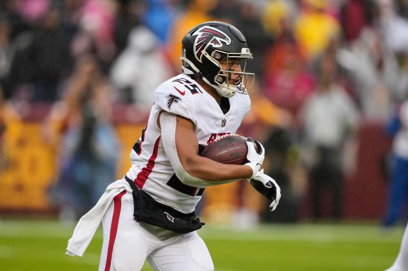 Atlanta Falcons running back Tyler Allgeier (25) runs with the ball during the second half of an NFL football game against the Washington Commanders, Sunday, Nov. 27, 2022, in Landover, Md. (AP Photo/Alex Brandon)