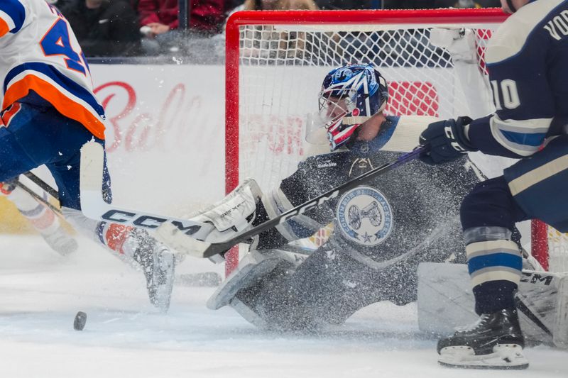 Apr 4, 2024; Columbus, Ohio, USA;  Columbus Blue Jackets goaltender Jet Greaves (73) makes a save in net against the New York Islanders in the second period at Nationwide Arena. Mandatory Credit: Aaron Doster-USA TODAY Sports