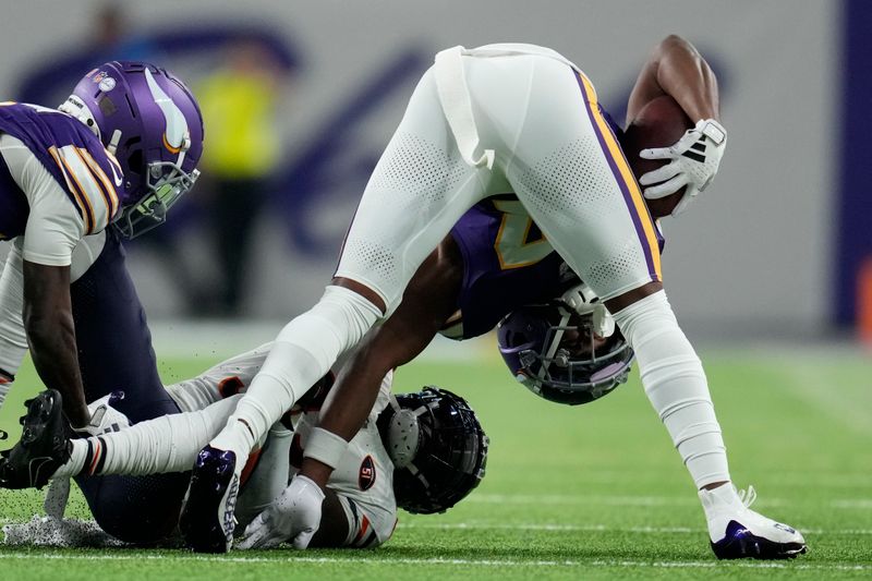 Minnesota Vikings wide receiver K.J. Osborn, right, is tackled by Chicago Bears cornerback Jaylon Johnson during the first half of an NFL football game, Monday, Nov. 27, 2023, in Minneapolis. (AP Photo/Abbie Parr)