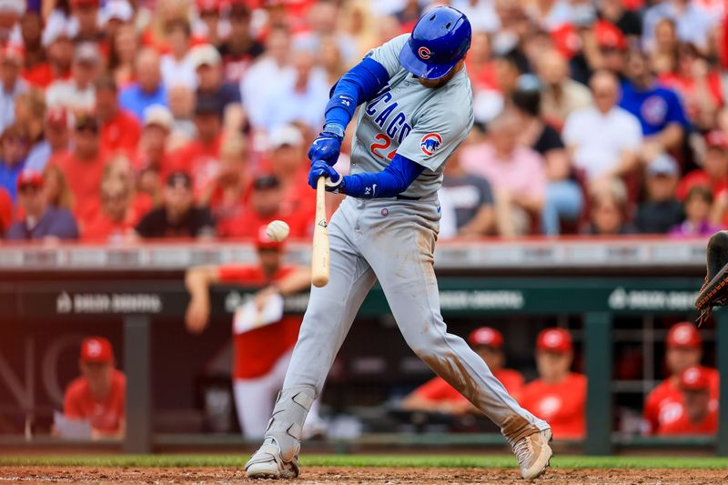 Jun 8, 2024; Cincinnati, Ohio, USA; Chicago Cubs outfielder Cody Bellinger (24) hits a single against the Cincinnati Reds in the third inning at Great American Ball Park. Mandatory Credit: Katie Stratman-USA TODAY Sports