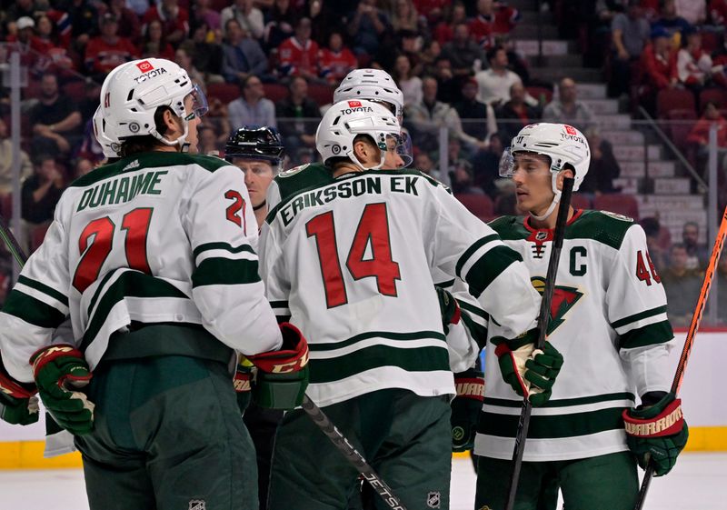 Oct 25, 2022; Montreal, Quebec, CAN; Minnesota Wild forward Joel Eriksson Ek (14) celebrates with teammates after scoring a goal against the Montreal Canadiens during the first period at the Bell Centre. Mandatory Credit: Eric Bolte-USA TODAY Sports