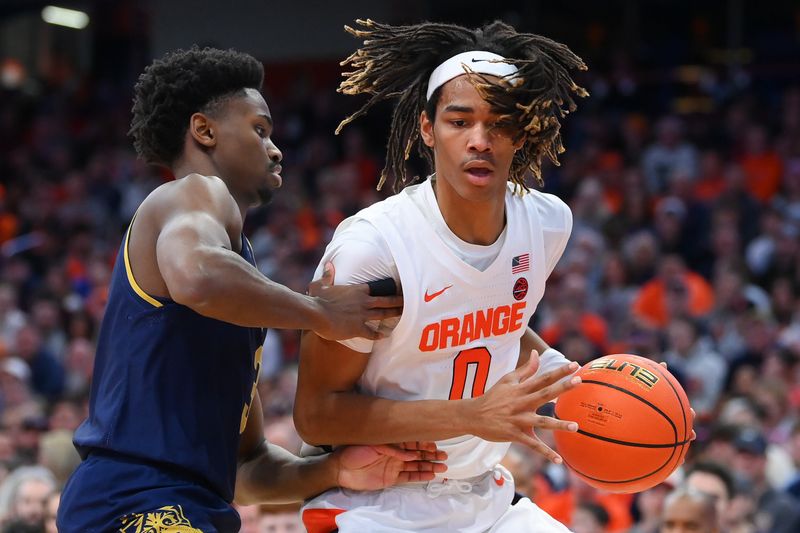 Jan 14, 2023; Syracuse, New York, USA; Syracuse Orange forward Chris Bell (0) drives to the basket as Notre Dame Fighting Irish guard Trey Wertz (3) defends during the first half at the JMA Wireless Dome. Mandatory Credit: Rich Barnes-USA TODAY Sports