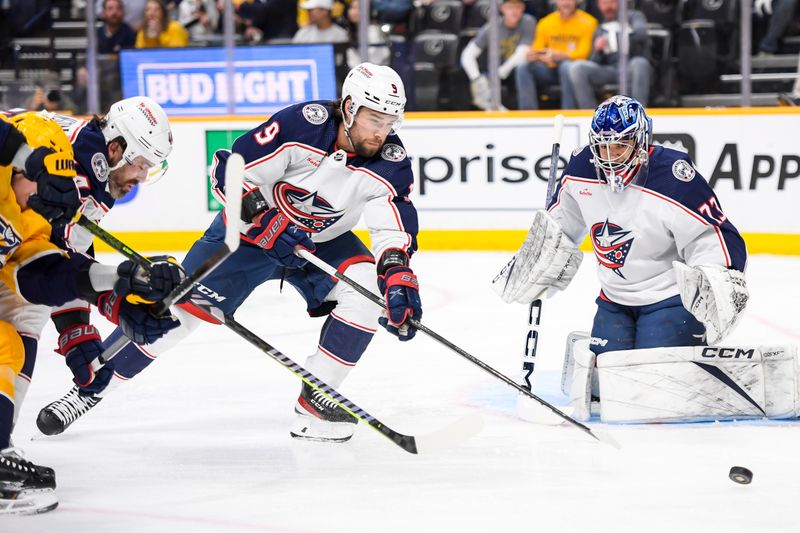 Apr 13, 2024; Nashville, Tennessee, USA; Columbus Blue Jackets defenseman Ivan Provorov (9) and goaltender Jet Greaves (73) blocks the shot of Nashville Predators center Tommy Novak (82) during the first period at Bridgestone Arena. Mandatory Credit: Steve Roberts-USA TODAY Sports