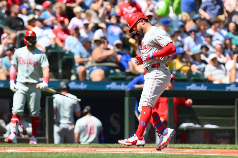 Aug 4, 2024; Seattle, Washington, USA; Philadelphia Phillies designated hitter Kyle Schwarber (12) crosses home plate after hitting a home run against the Seattle Mariners during the first inning at T-Mobile Park. Mandatory Credit: Steven Bisig-USA TODAY Sports