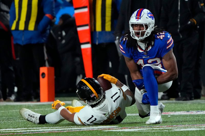 Buffalo Bills linebacker Dorian Williams (42) reacts after tackling Pittsburgh Steelers wide receiver Allen Robinson II (11) during an NFL wild-card playoff football game, Monday, Jan. 15, 2024 in in Orchard Park, NY. (AP Photo/Rick Scuteri)