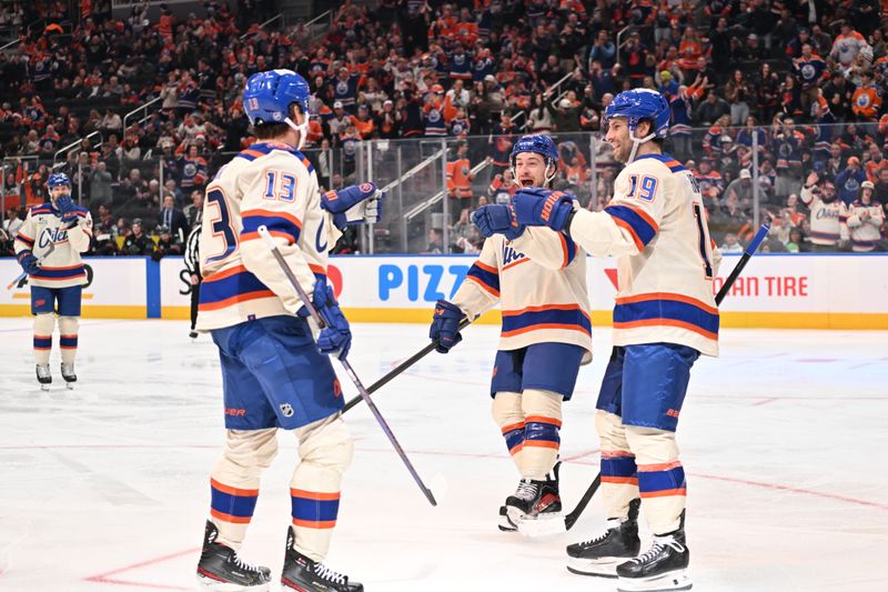Dec 4, 2025; Edmonton, Alberta, CAN; Edmonton Oilers center Mattias Janmark (13) Oilers left winger Andrew Maggiapane (88) and Oilers center Adam Henrique (19) celebrate a goal on Seattle Kraken goalie Phillip Grubauer (31) during the third period at Rogers Place. Mandatory Credit: Walter Tychnowicz-Imagn Images