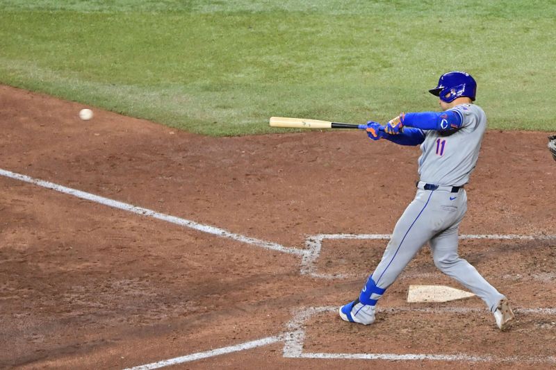 Aug 29, 2024; Phoenix, Arizona, USA;  New York Mets second base Jose Iglesias (11) hits an RBI single in the ninth inning against the Arizona Diamondbacks at Chase Field. Mandatory Credit: Matt Kartozian-USA TODAY Sports