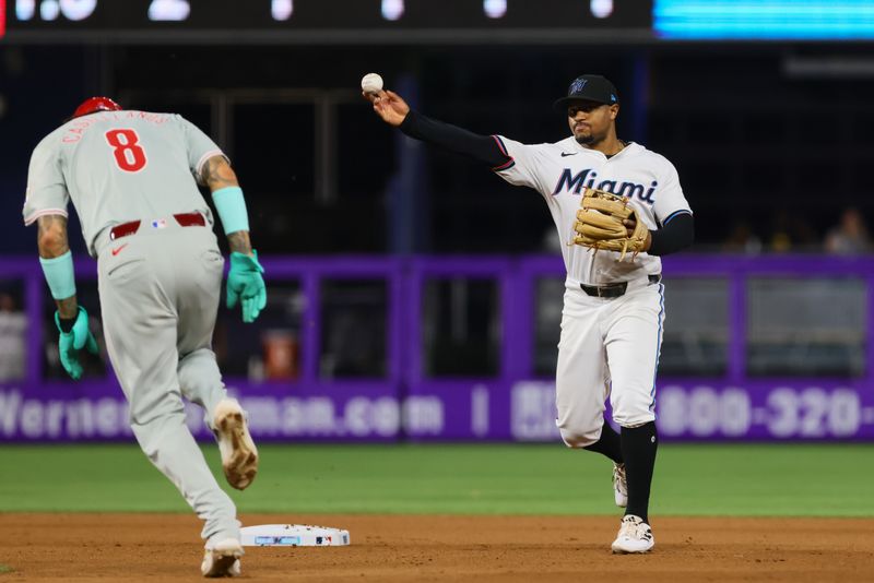 Sep 5, 2024; Miami, Florida, USA; Miami Marlins shortstop Xavier Edwards (63) turns a double play against the Philadelphia Phillies during the seventh inning at loanDepot Park. Mandatory Credit: Sam Navarro-Imagn Images