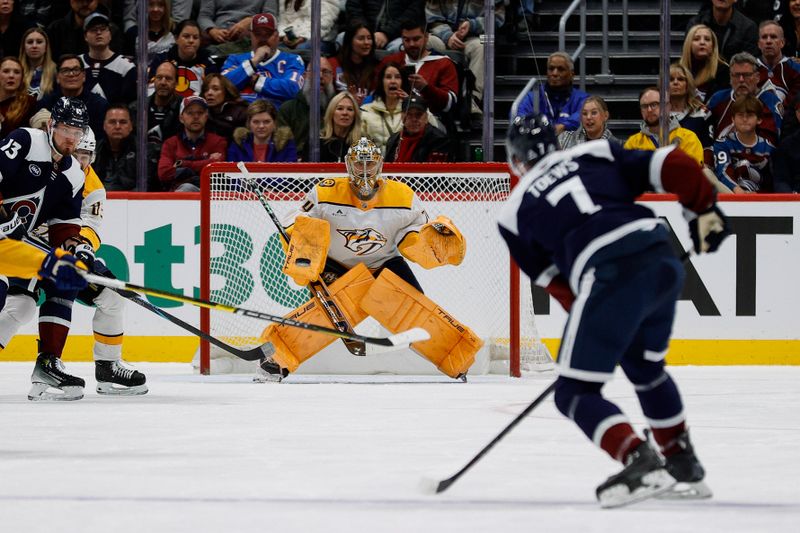 Dec 14, 2024; Denver, Colorado, USA; Colorado Avalanche defenseman Devon Toews (7) takes a shot against Nashville Predators goaltender Juuse Saros (74) in the first period at Ball Arena. Mandatory Credit: Isaiah J. Downing-Imagn Images