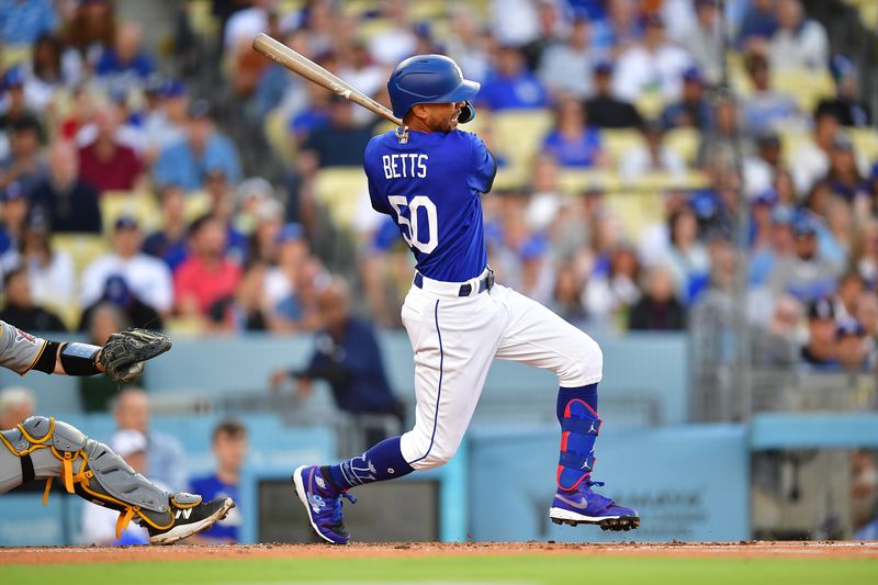 Jul 6, 2023; Los Angeles, California, USA; Los Angeles Dodgers second baseman Mookie Betts (50) hits a double against the Pittsburgh Pirates during the first inning at Dodger Stadium. Mandatory Credit: Gary A. Vasquez-USA TODAY Sports