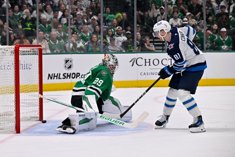 Apr 10, 2025; Dallas, Texas, USA; Winnipeg Jets left wing Kyle Connor (81) scores a goal against Dallas Stars goaltender Jake Oettinger (29) during the third period at the American Airlines Center. Mandatory Credit: Jerome Miron-Imagn Images