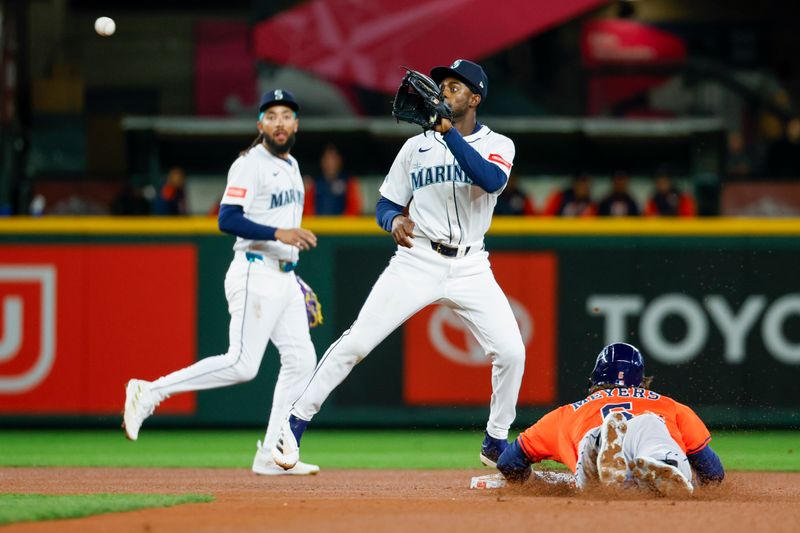 Apr 8, 2025; Seattle, Washington, USA; Seattle Mariners second baseman Ryan Bliss (1) catches a throw from the catcher as Houston Astros center fielder Jake Meyers (6) steals second base during the third inning at T-Mobile Park. Mandatory Credit: Joe Nicholson-Imagn Images
