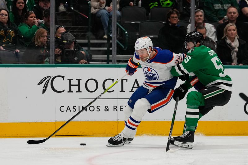 Feb 17, 2024; Dallas, Texas, USA;  Edmonton Oilers center Leon Draisaitl (29) and Dallas Stars defenseman Thomas Harley (55) chase the puck during the first period at American Airlines Center. Mandatory Credit: Chris Jones-USA TODAY Sports