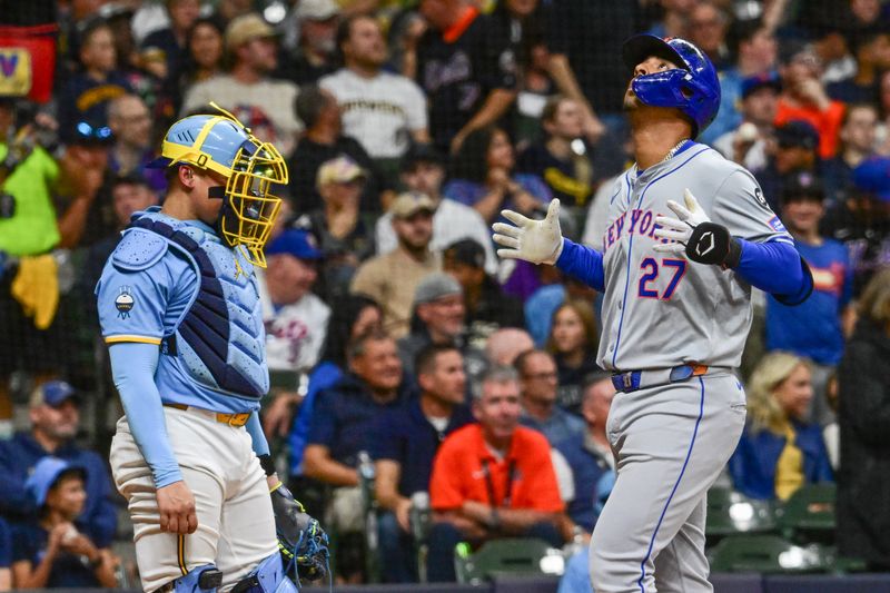 Sep 27, 2024; Milwaukee, Wisconsin, USA; New York Mets third baseman Mark Vientos (27) reacts after hitting a two-run home run in the third inning as Milwaukee Brewers catcher William Contreras (24) looks on at American Family Field. Mandatory Credit: Benny Sieu-Imagn Images