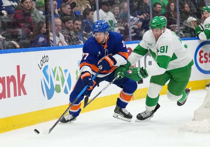 Mar 17, 2026; Toronto, Ontario, CAN; Toronto Maple Leafs center John Tavares (91) battles for the puck with New York Islanders defenseman Tony DeAngelo (77) during the first period at Scotiabank Arena. Mandatory Credit: Nick Turchiaro-Imagn Images