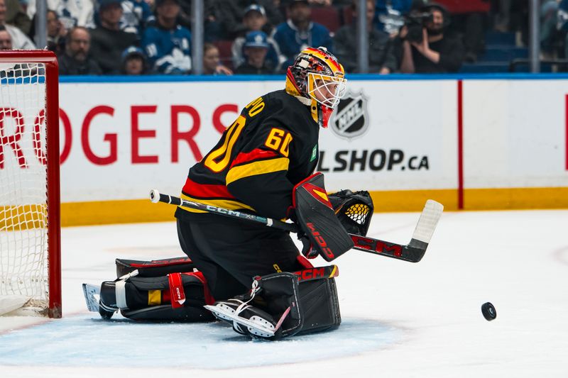 Jan 31, 2026; Vancouver, British Columbia, CAN; Vancouver Canucks goalie Nikita Tolopilo (60) makes a save against the Toronto Maple Leafs in the first period at Rogers Arena. Mandatory Credit: Bob Frid-Imagn Images