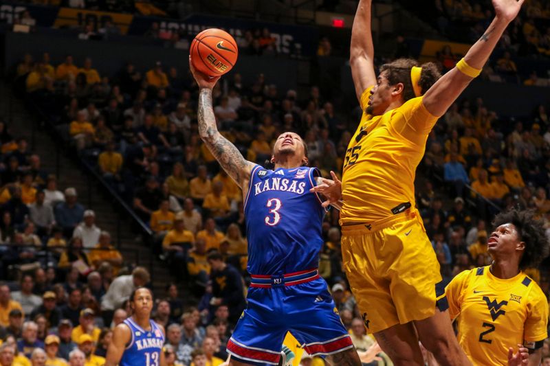 Jan 10, 2026; Morgantown, West Virginia, USA; Kansas Jayhawks guard Tre White (3) shoots against West Virginia Mountaineers center Harlan Obioha (55) during the first half at Hope Coliseum. Mandatory Credit: Ben Queen-Imagn Images