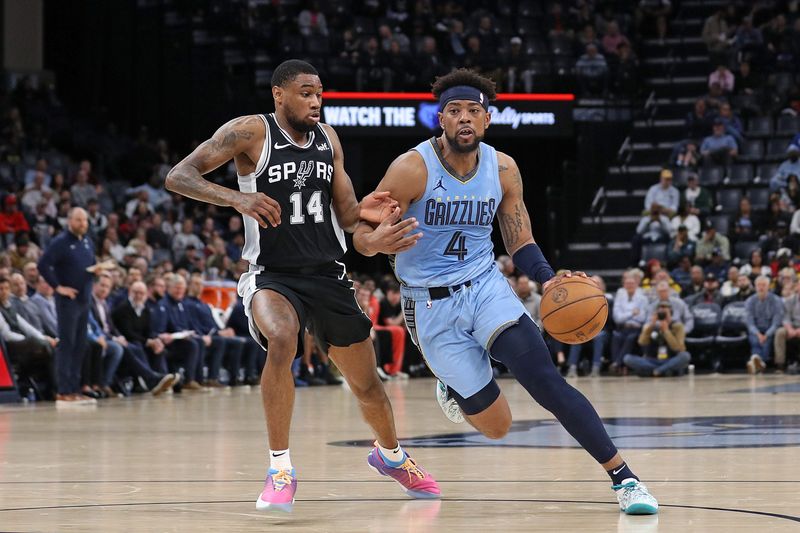 MEMPHIS, TENNESSEE - APRIL 09: Jordan Goodwin #4 of the Memphis Grizzlies drives to the basket against Blake Wesley #14 of the San Antonio Spurs during the first half at FedExForum on April 09, 2024 in Memphis, Tennessee. NOTE TO USER: User expressly acknowledges and agrees that, by downloading and or using this photograph, User is consenting to the terms and conditions of the Getty Images License Agreement. (Photo by Justin Ford/Getty Images)